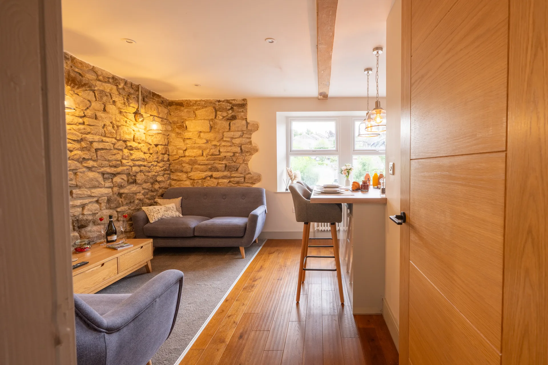 Open-plan living area with a sofa and breakfast bar