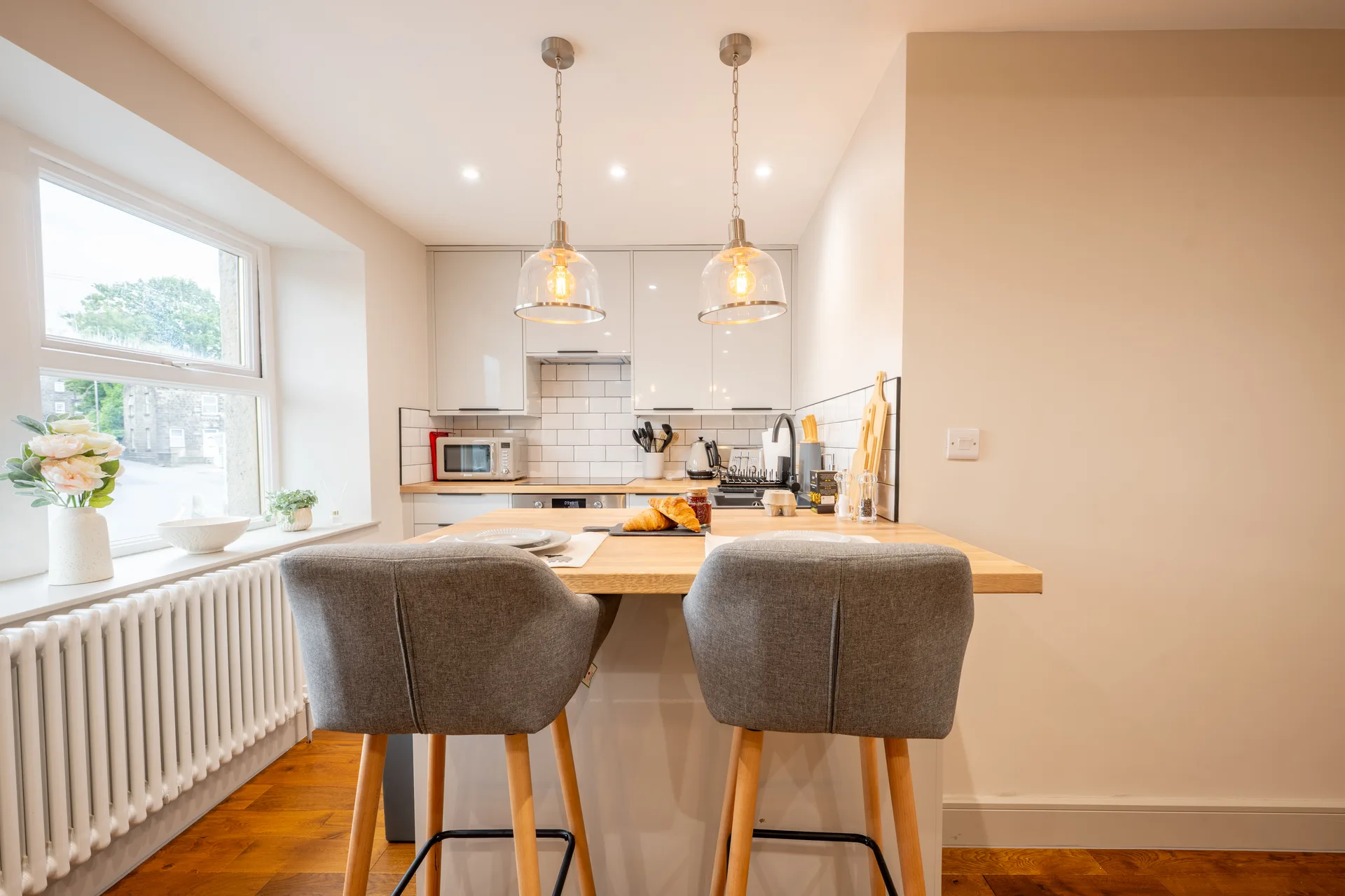 Breakfast bar with stools beside the kitchen window